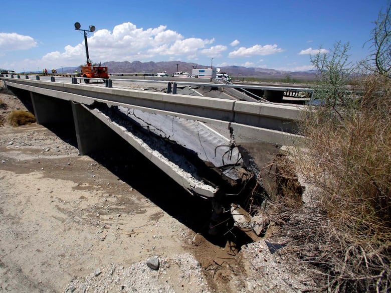 Damage is seen from a washed out bridge near the town of Desert Center, Calif., along Interstate I-10, Monday, July 20, 2015. All traffic along one of the major highways connecting California and Arizona was blocked indefinitely when the bridge over 